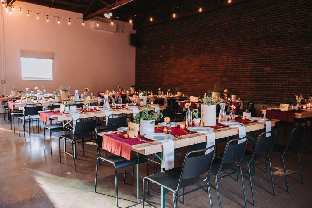 Sustainable wedding tip: keep your guest list small. Photo shows chairs and tables set up with cutlery and plants for a wedding.
