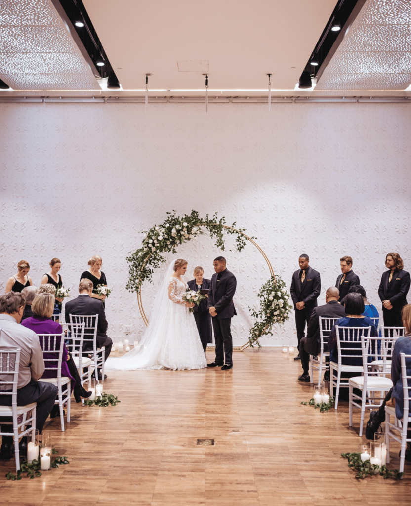 Image of a couple getting married infront of family and friends at one of their Minneapolis Wedding Venues The Blaisdell. 