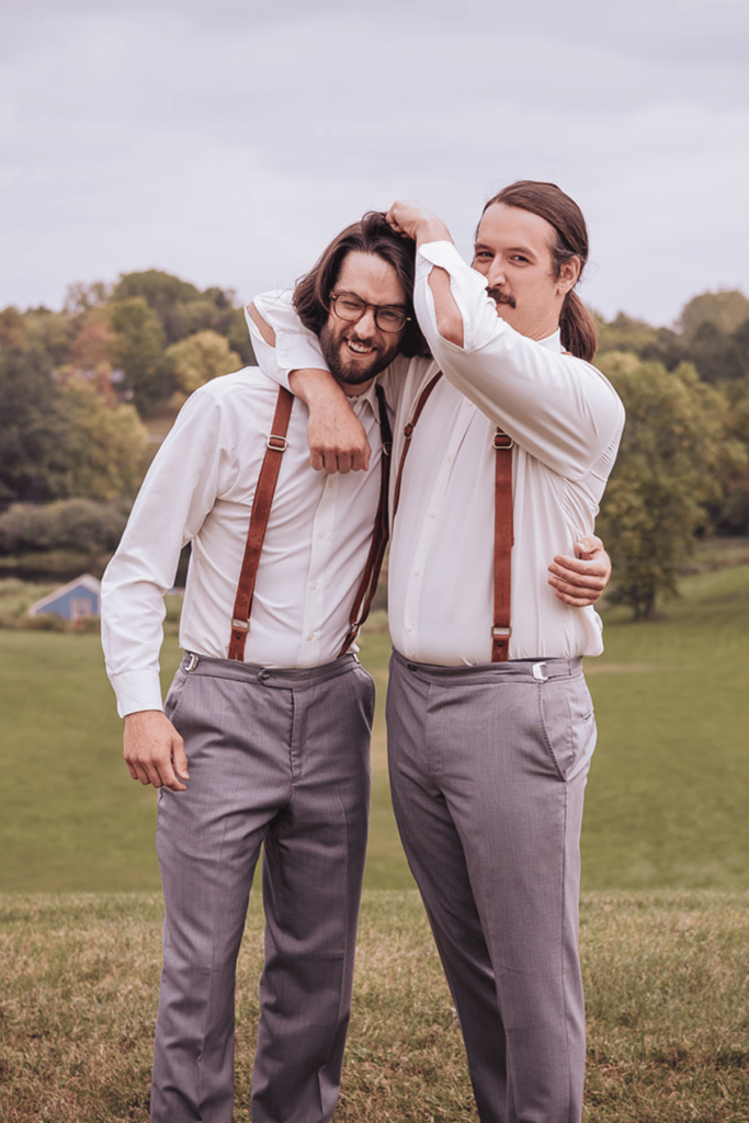 Image of groom and best man being silly for wedding party photos. 