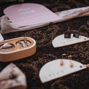 Wedding photography image of details such as earrings, rings and wedding invitation showing the importance when booking a wedding photographer of someone who will capture it all! 
