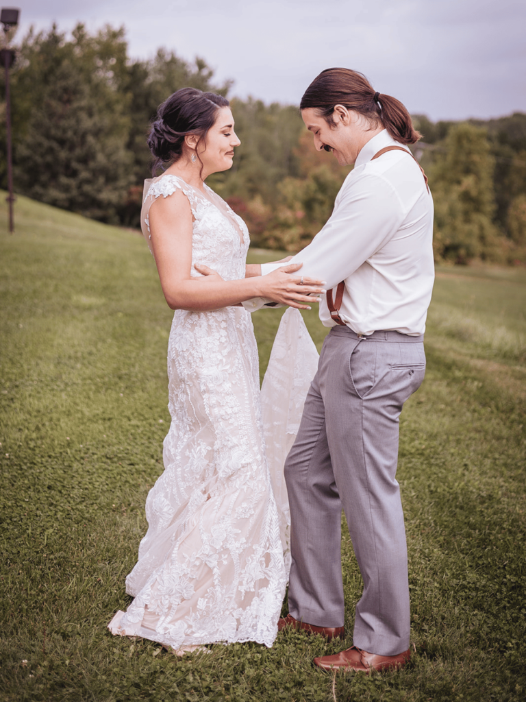 Image of a bride and groom happily looking at each other and enjoying this intimate moment together. 
