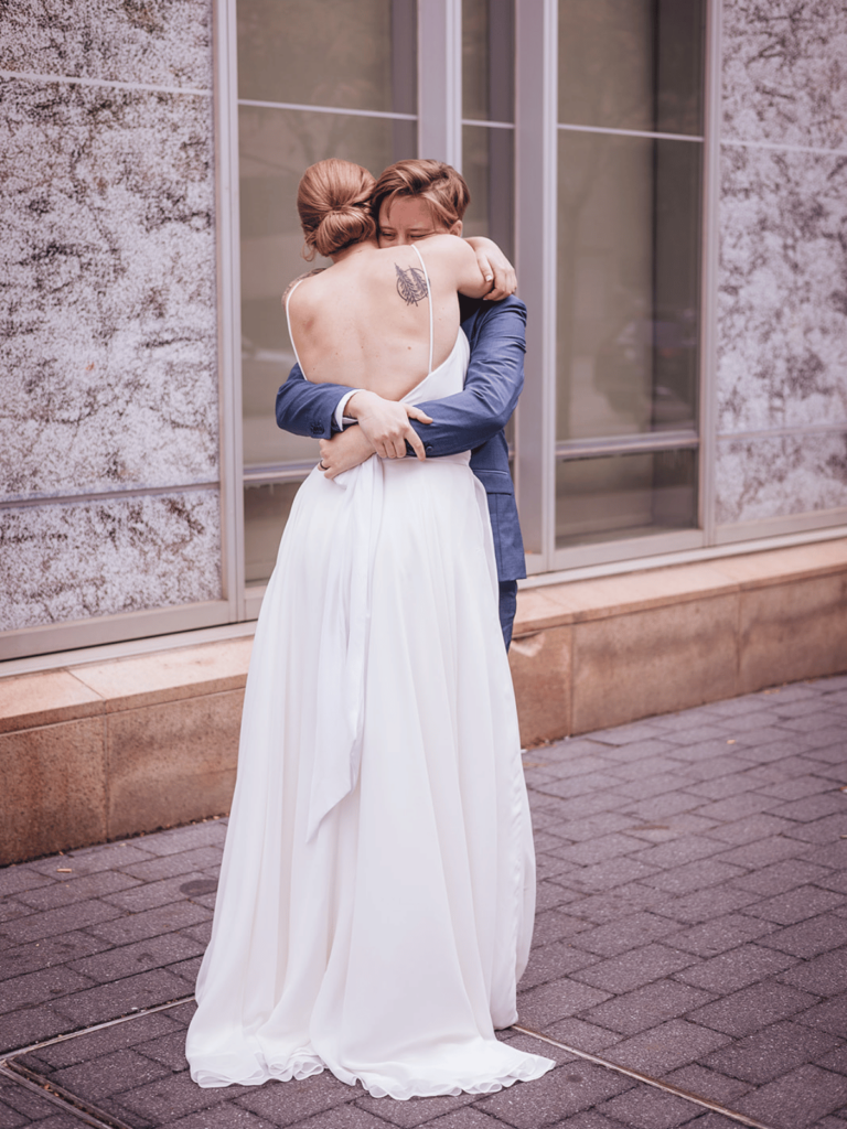 A couple embracing in happiness after a wedding first look. 