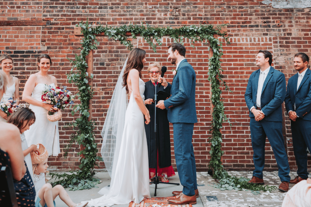 Image of bride and groom getting married at an outdoor MN wedding showing the importance of considering indoor or outdoor wedding with how to start planning a wedding. 