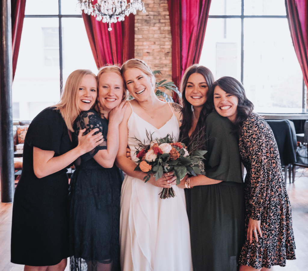 Image of a bride standing with 4 female friends showing creating holiday and gift ideas using family and wedding party photos. Great idea for what to do with wedding photos. 