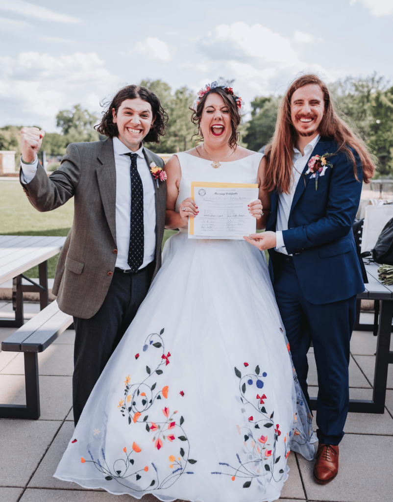 Image of a couple holding their Marriage Certificate. 
