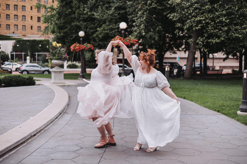 St. Paul Hotel wedding venue in the background as a couple poses outside