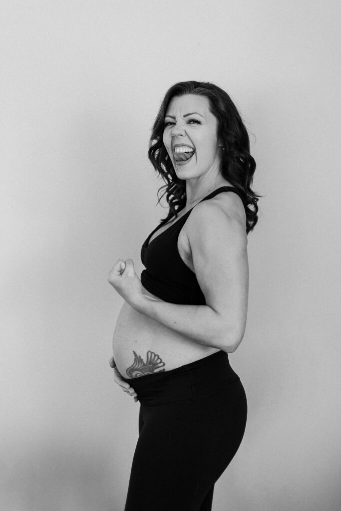 Pregnant woman with tattoo poses during her maternity photoshoot in the Twin Cities