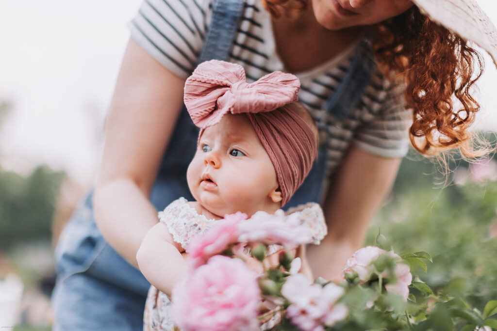 Mother and baby in a flower garden during their Minneapolis newborn photography session